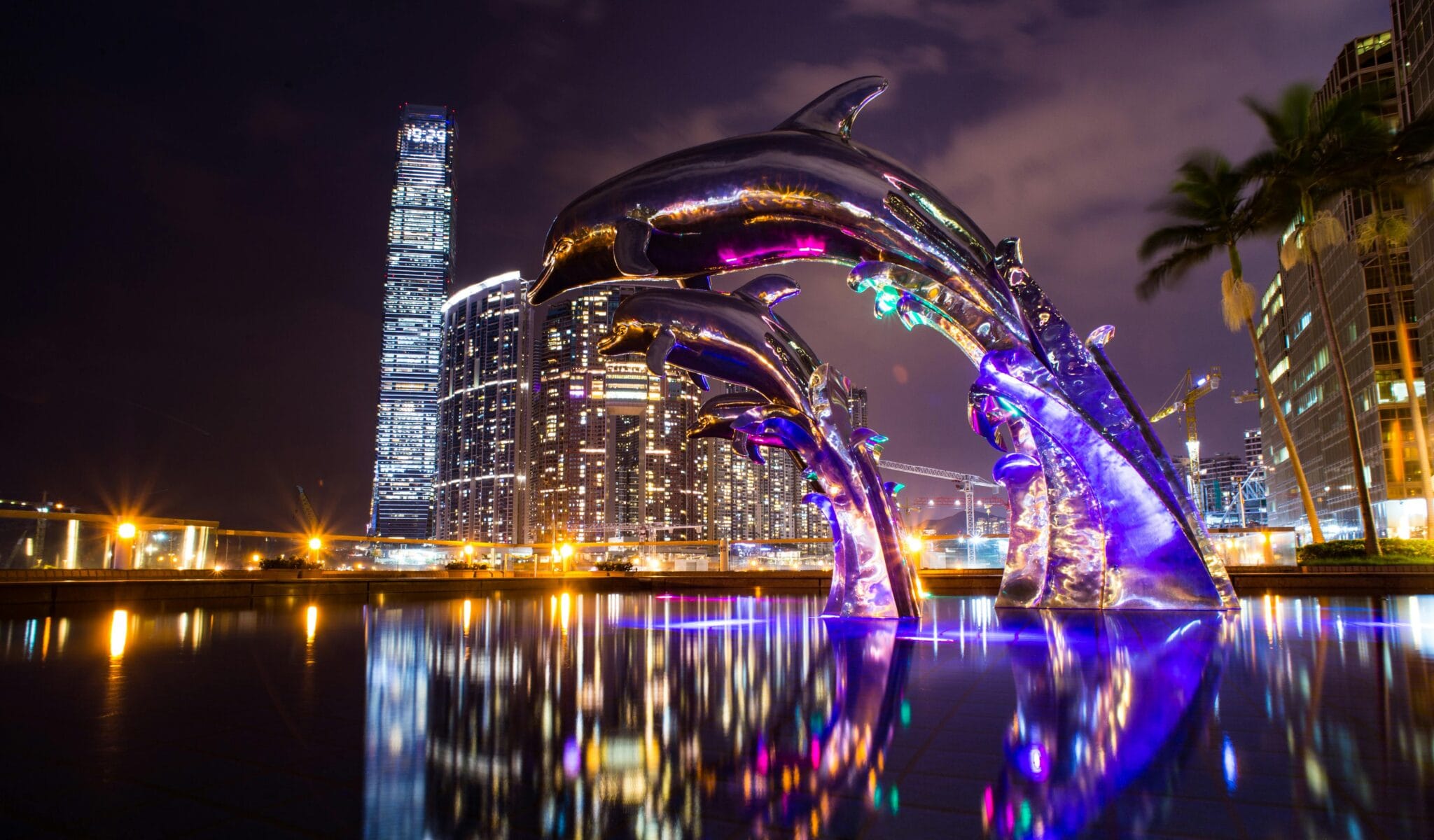 Calles de Hong Kong con rótulos de neón y reflejos sobre el asfalto mojado cerca del puerto Victoria.